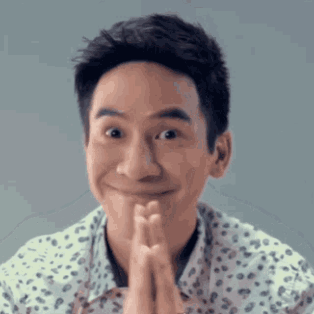 a man is praying with his hands folded in front of his face