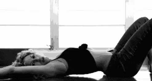 a woman is laying on her stomach on the floor .