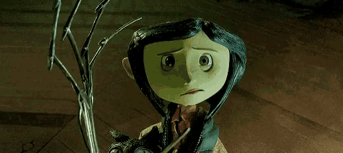coraline from coraline the animated movie is holding a cat