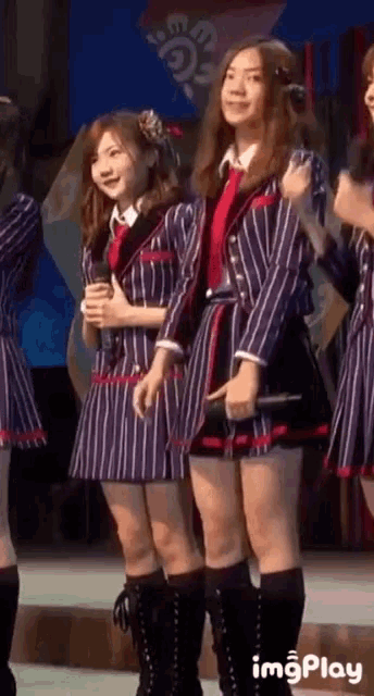 a girl in a striped dress is holding a microphone