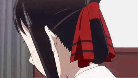 a girl with a red bow in her hair is looking down