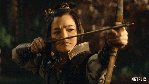 a woman is holding a bow and arrow with a netflix logo in the background