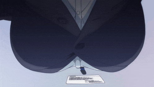 a woman in a suit is sitting at a desk with a piece of paper on the table
