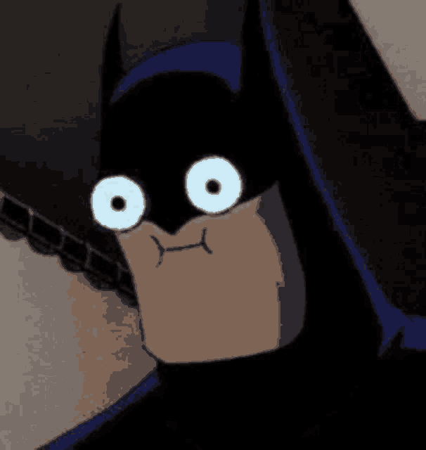 a close up of a cartoon batman with big white eyes and a tongue sticking out .