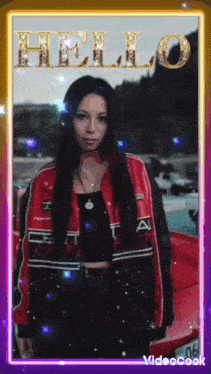 a woman in a red jacket is standing in front of a red car with the word hello written in gold letters
