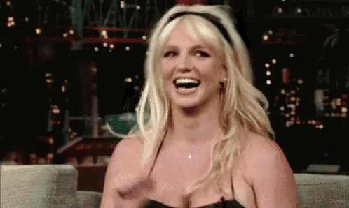 britney spears is laughing while wearing a headband