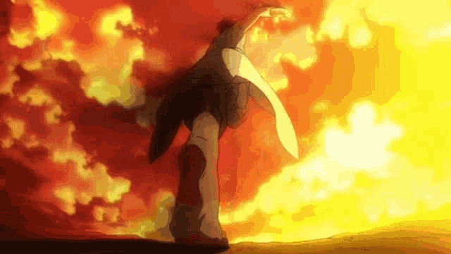 a man is standing in front of a sunset and holding a sword .