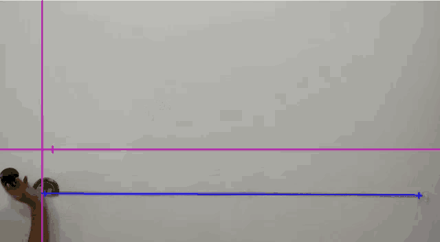 a person 's hand is pointing at a purple line with numbers on it