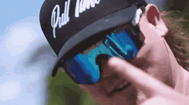 a man wearing sunglasses and a hat that says drill town