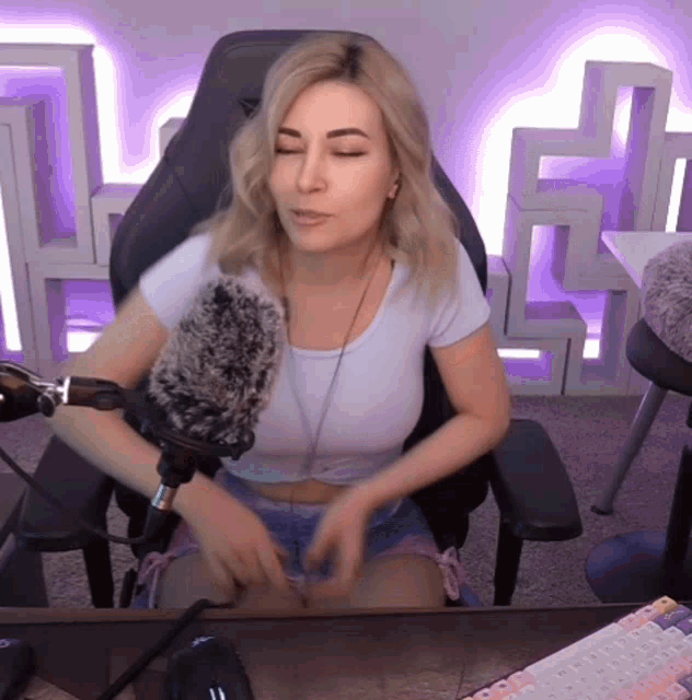 a woman is sitting in a chair with a microphone in front of her .