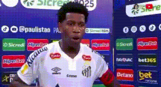 a man in a soccer uniform is standing in front of a sign that says ' bet365 ' .