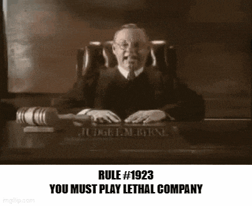 a judge is sitting at a desk in a courtroom holding a hammer .