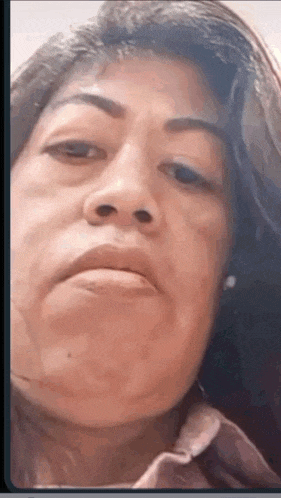 a close up of a woman 's face with a serious expression .