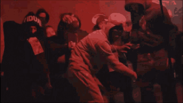 a man is dancing in front of a crowd with a sign that says nova vida
