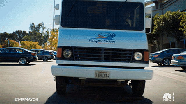 a pacific chicken truck is parked on the street