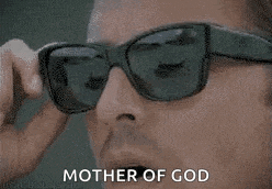 a woman wearing sunglasses is holding a cell phone to her face .