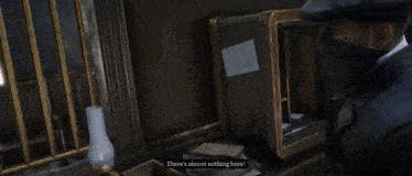 a man holding a gun in front of a safe with the words " there 's almost nothing here " on the bottom