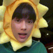 a young man wearing a yellow sun hat and a green shirt .
