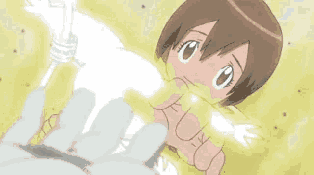 a cartoon girl is being held by a person 's hand .
