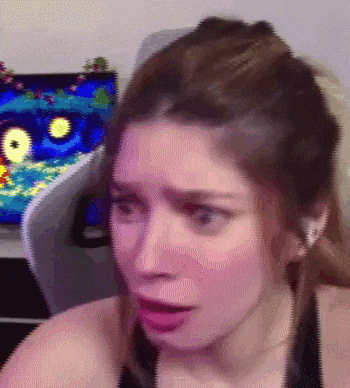 a close up of a woman 's face with a video game in the background