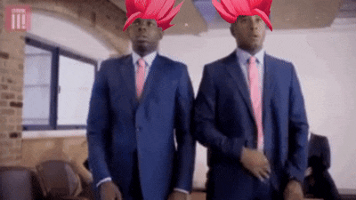 two men in suits and ties are standing next to each other in an office .