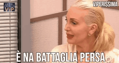 a woman with a ponytail says " e na battaglia persa "