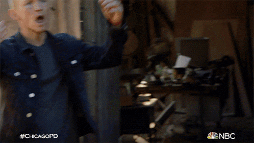 a man in a denim jacket holds his hand to his forehead with the hashtag #chicagopd
