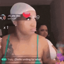 a woman wearing a white hat and a green tank top is smiling for what