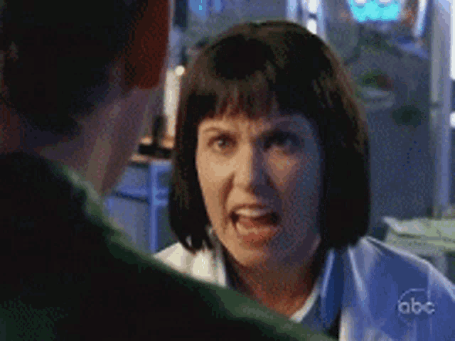 a woman is yelling at a man with abc written on the bottom