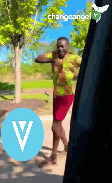 a man is dancing in front of a sign that says changeangel on it