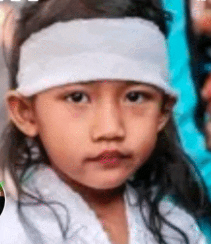a young girl wearing a white headband and a white hat .