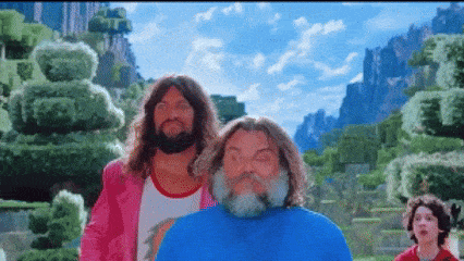 a man with a beard is standing next to another man