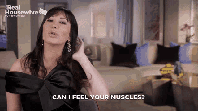 a woman says can i feel your muscles in front of a couch