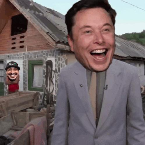 a man in a suit and tie is laughing in front of a house with a picture of elon musk behind him