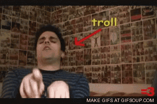 a gif of a man pointing at a wall with the word troll on it