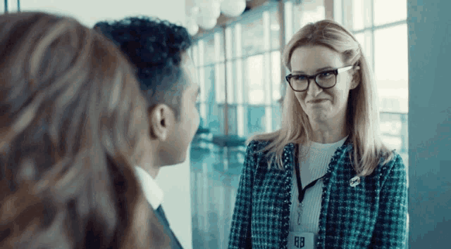 a woman wearing glasses has a name tag that says rb