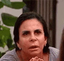a close up of a woman making a funny face while looking at the camera .