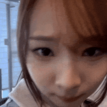 a close up of a woman 's face looking at the camera .
