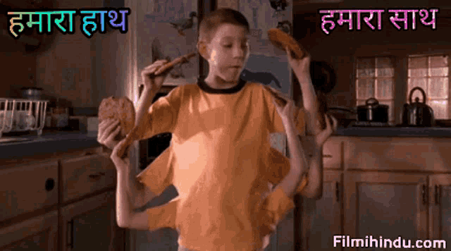 a boy with many arms is eating a pizza in a kitchen with the words " filmihindu.com " on the bottom right