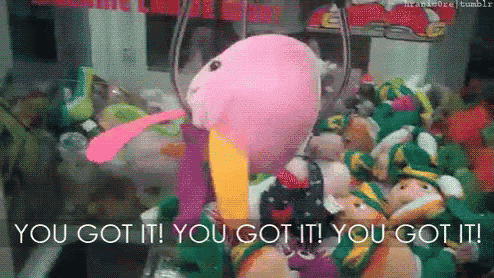 a stuffed animal in a claw machine with the words you got it on the bottom