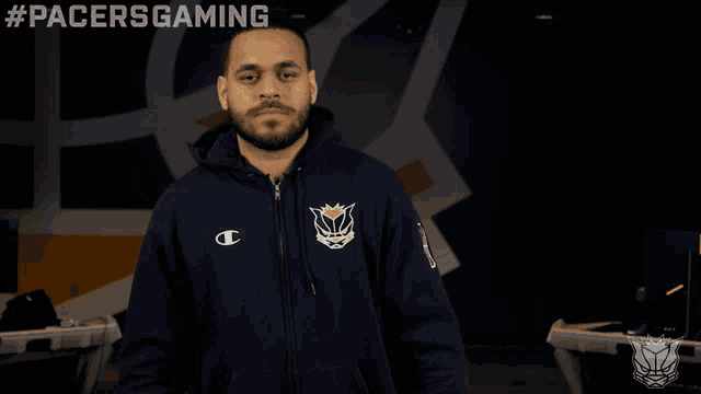 a man wearing a champion hoodie with the pacers logo on the front