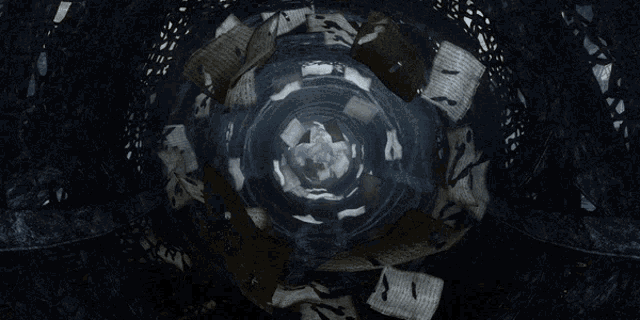 a bunch of papers floating in a dark room