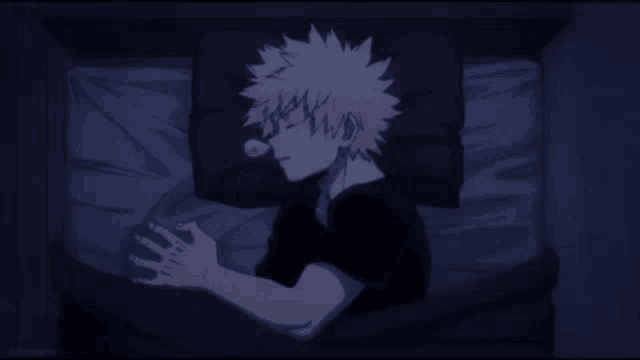 a young boy is sleeping in a bed with a bubble in his mouth .