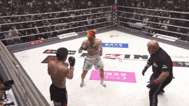a man in a boxing ring with a pink sign that says ' rzn ' on it
