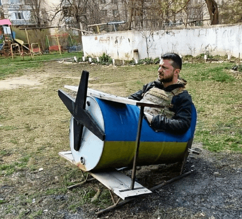 a man sits in a barrel with a propeller on it