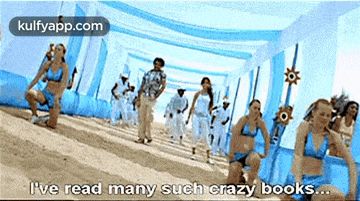 a group of women in bikinis are dancing on a beach and one of them says i 've read many such crazy books ..