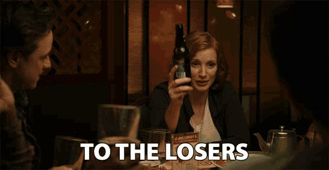 a group of people are toasting with wine glasses and beer bottles and the words to the losers are visible