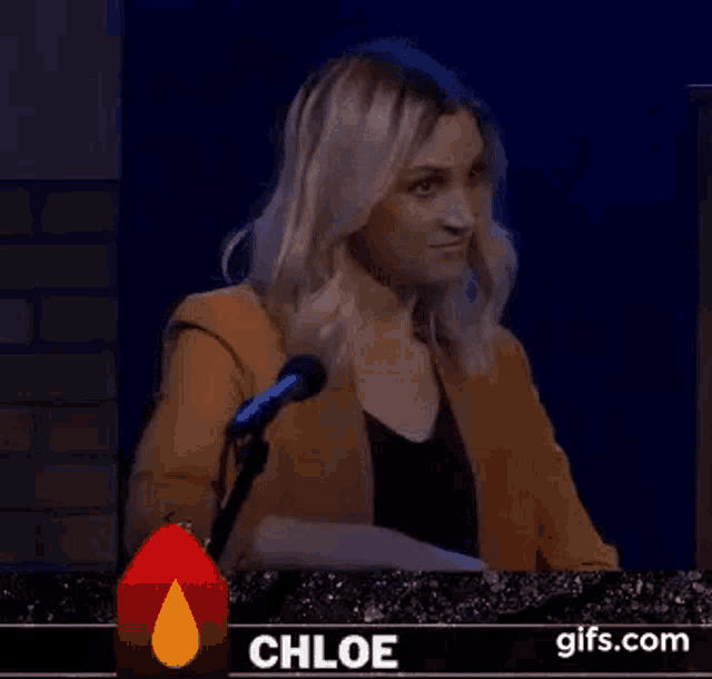 a woman is sitting in front of a microphone with the words `` so much for that '' written on the screen .