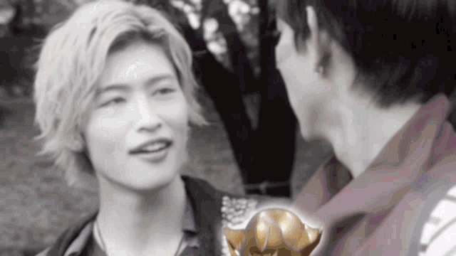 two men are looking at each other with a trophy in the background