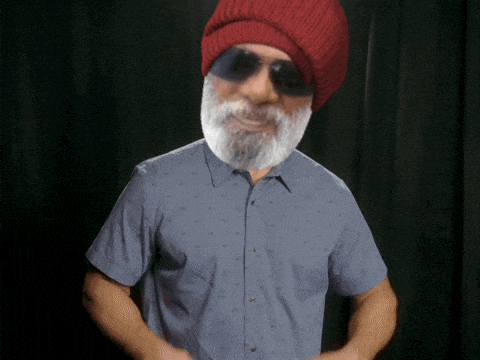 a man with a beard wearing sunglasses and a red beanie